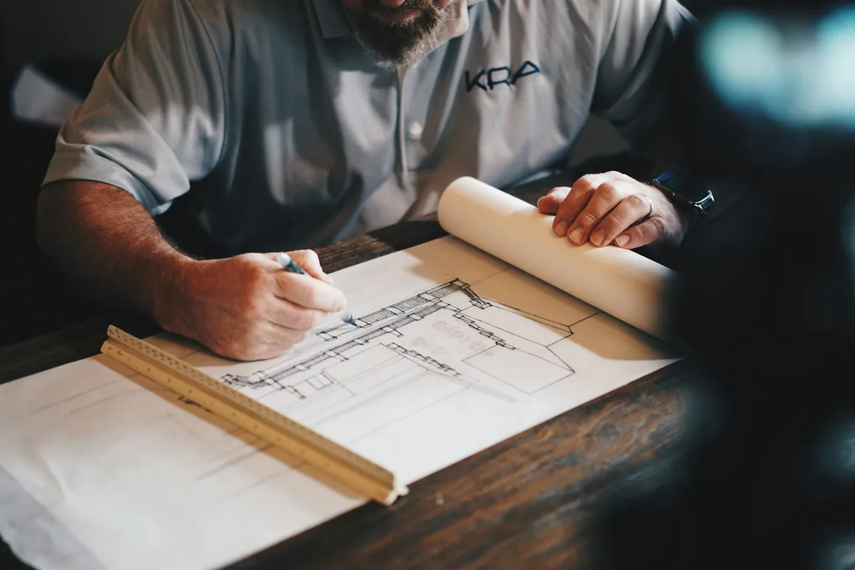 Architect marking a drawing with a pencil and ruler