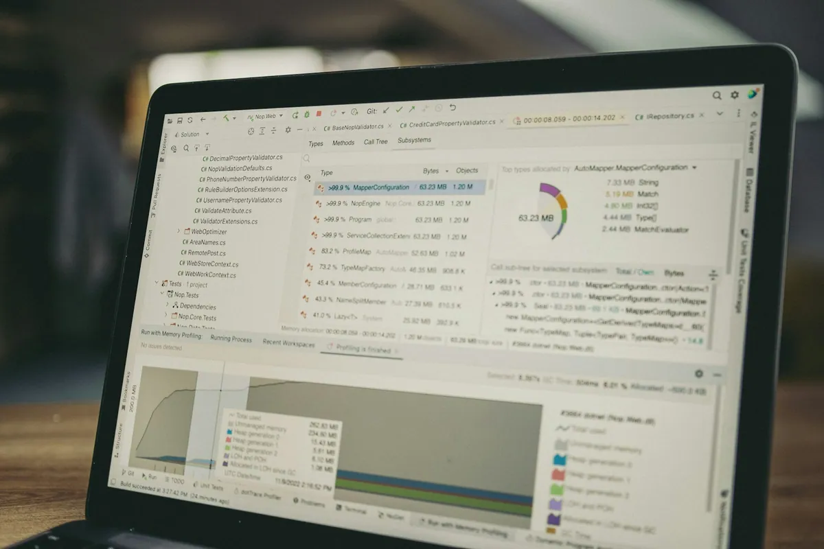 Laptop displaying analysis code, charts and a data table