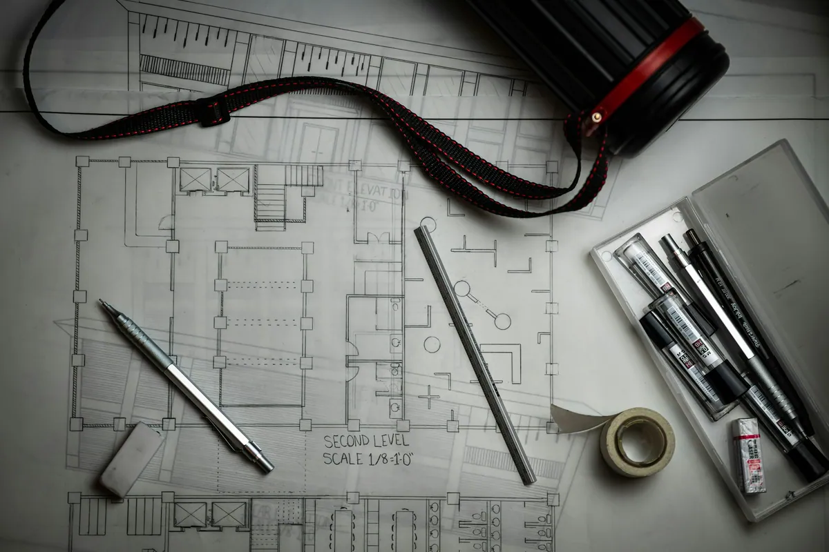 Architectural drawing with drafting tools and pens