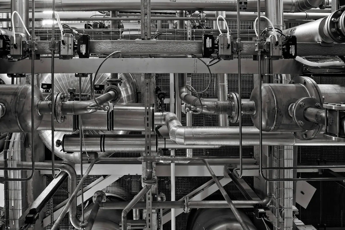 Industrial pipes and valves inside a process facility
