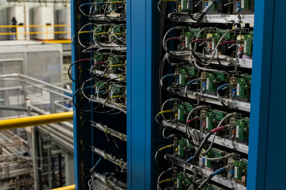 Open server cabinets showing cables, equipment and service connections